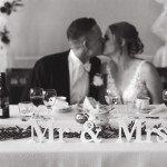 Vietä unohtumaton juhlapäivä Tiittalan kartanossa. Hääpari pöydän ääressä.